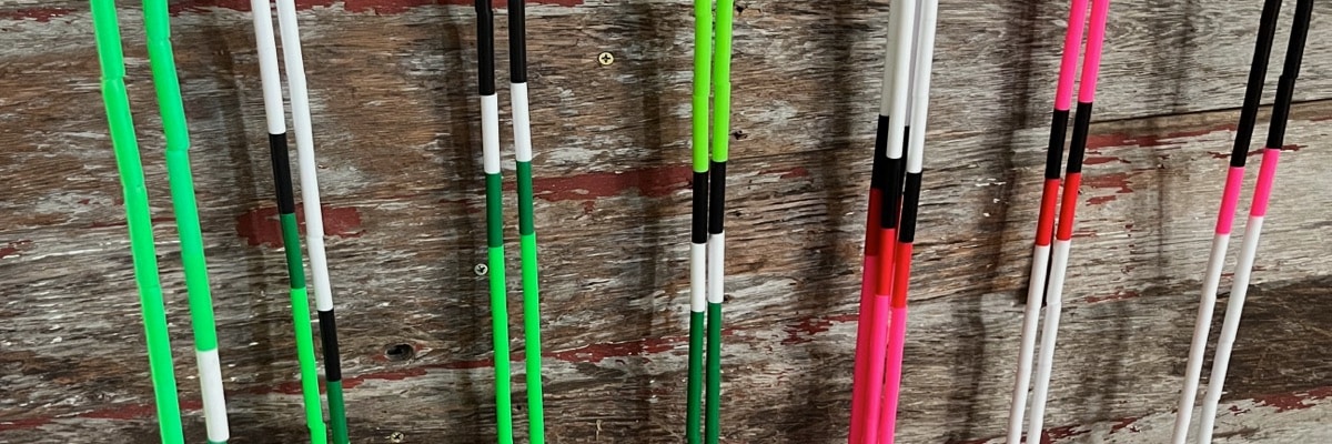 Colorful beaded jump ropes against wooden wall